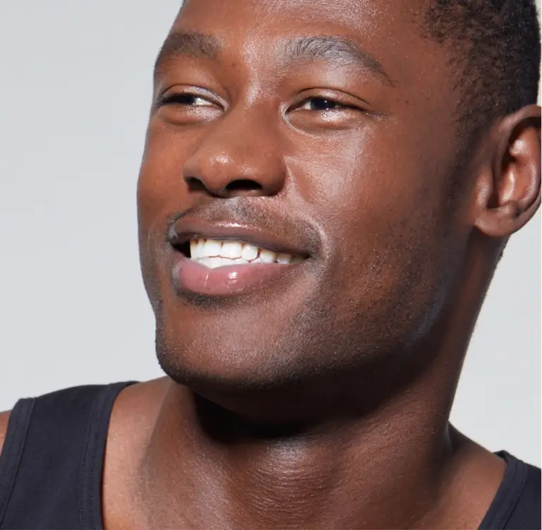 Client smiling with clear, healthy skin after treatment